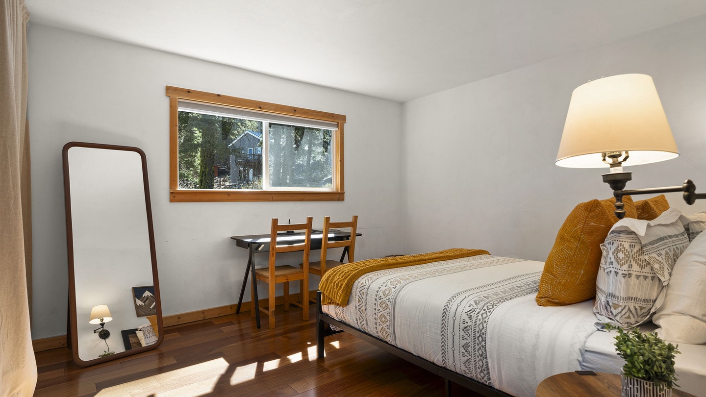 Sink into comfort in your serene bedroom, where warm sunlight streams through the window and thoughtful touches create a peaceful retreat.