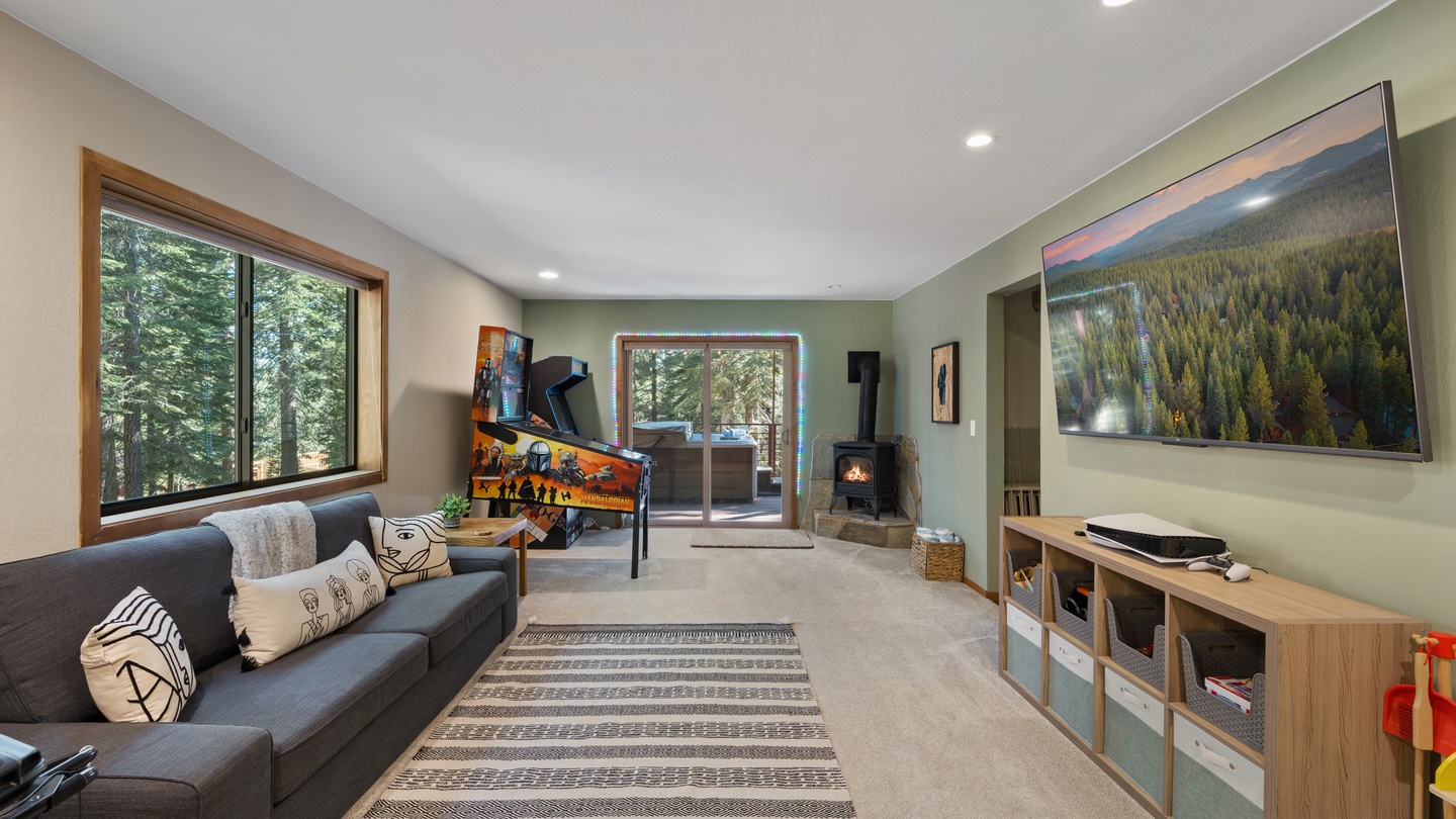 Your serene mountain retreat awaits, with a cozy fireplace, forest views through picture windows, and a thoughtfully designed space that blends comfort with natural beauty.