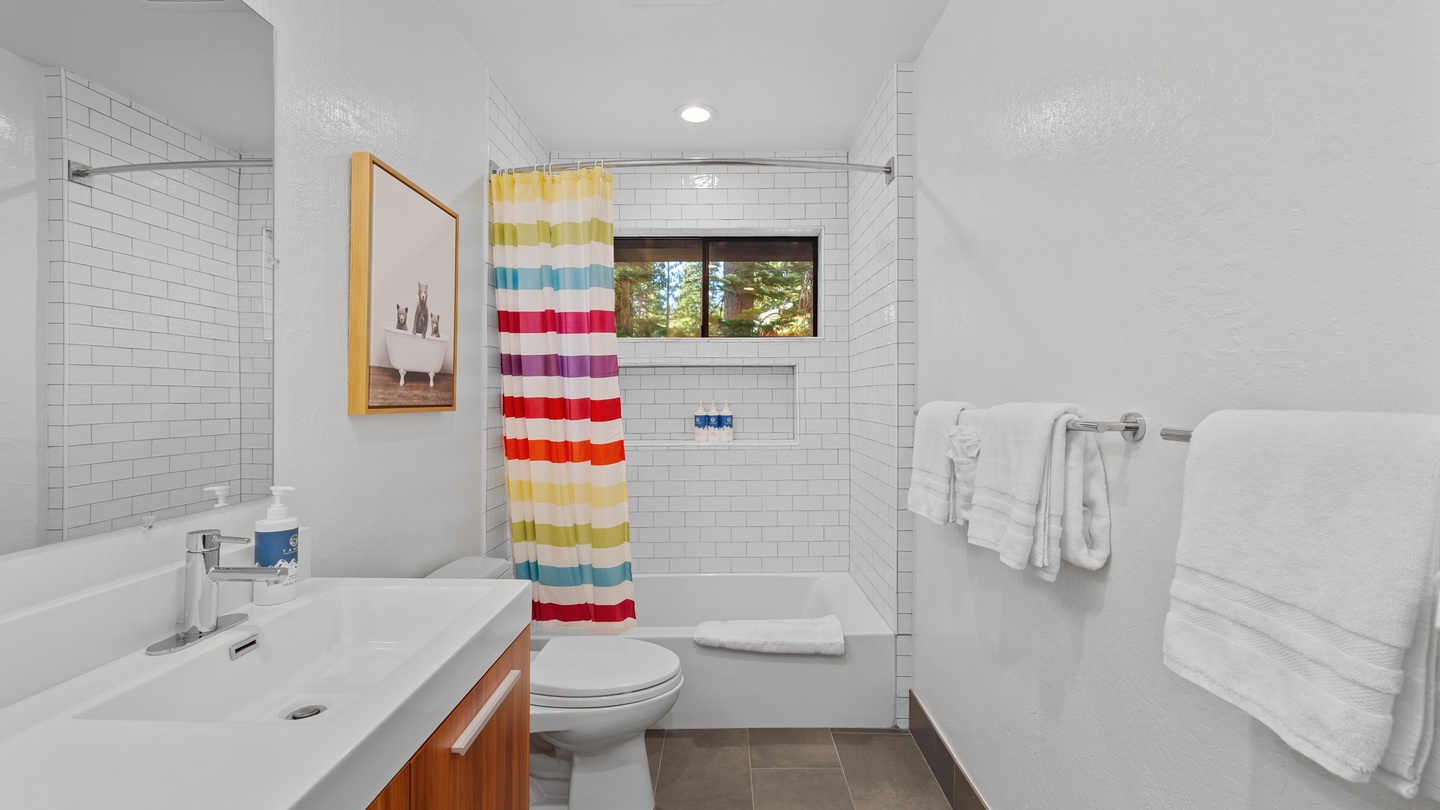 Step into your bright, clean bathroom with fresh subway tile, a spacious shower, and cheerful pops of color. Everything you need for a refreshing morning routine, right at your fingertips.