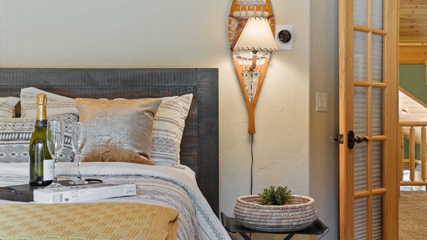 Step into your cozy retreat with its charming rustic touches and warm mountain ambiance. Sink into plush bedding and unwind with a celebratory glass of champagne as soft lighting sets the perfect mood for relaxation.