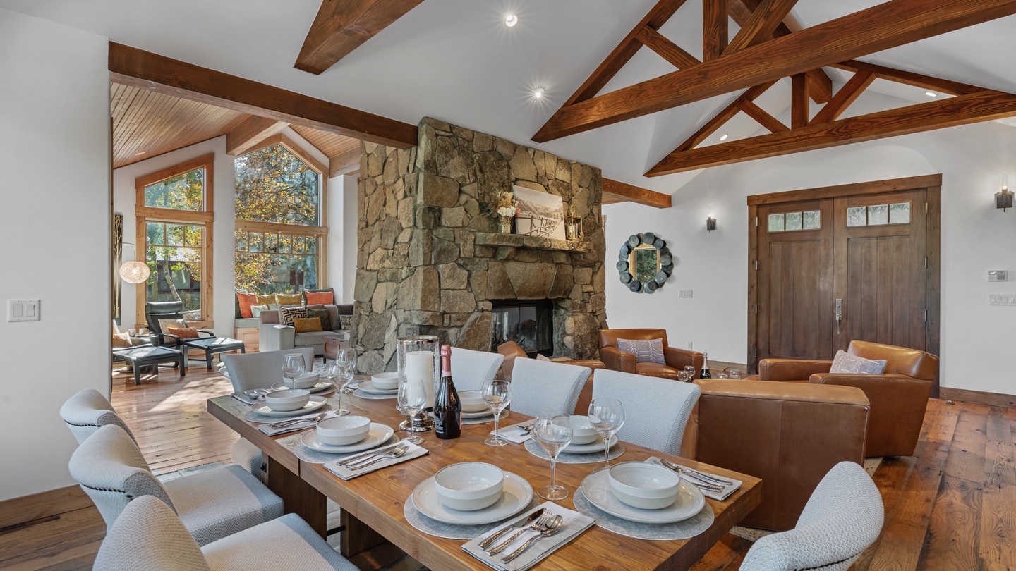 Soaring timber beams and a rustic stone fireplace set the stage for your mountain retreat, where you'll gather around the table for memorable meals and unwind by the warmth of the fire.