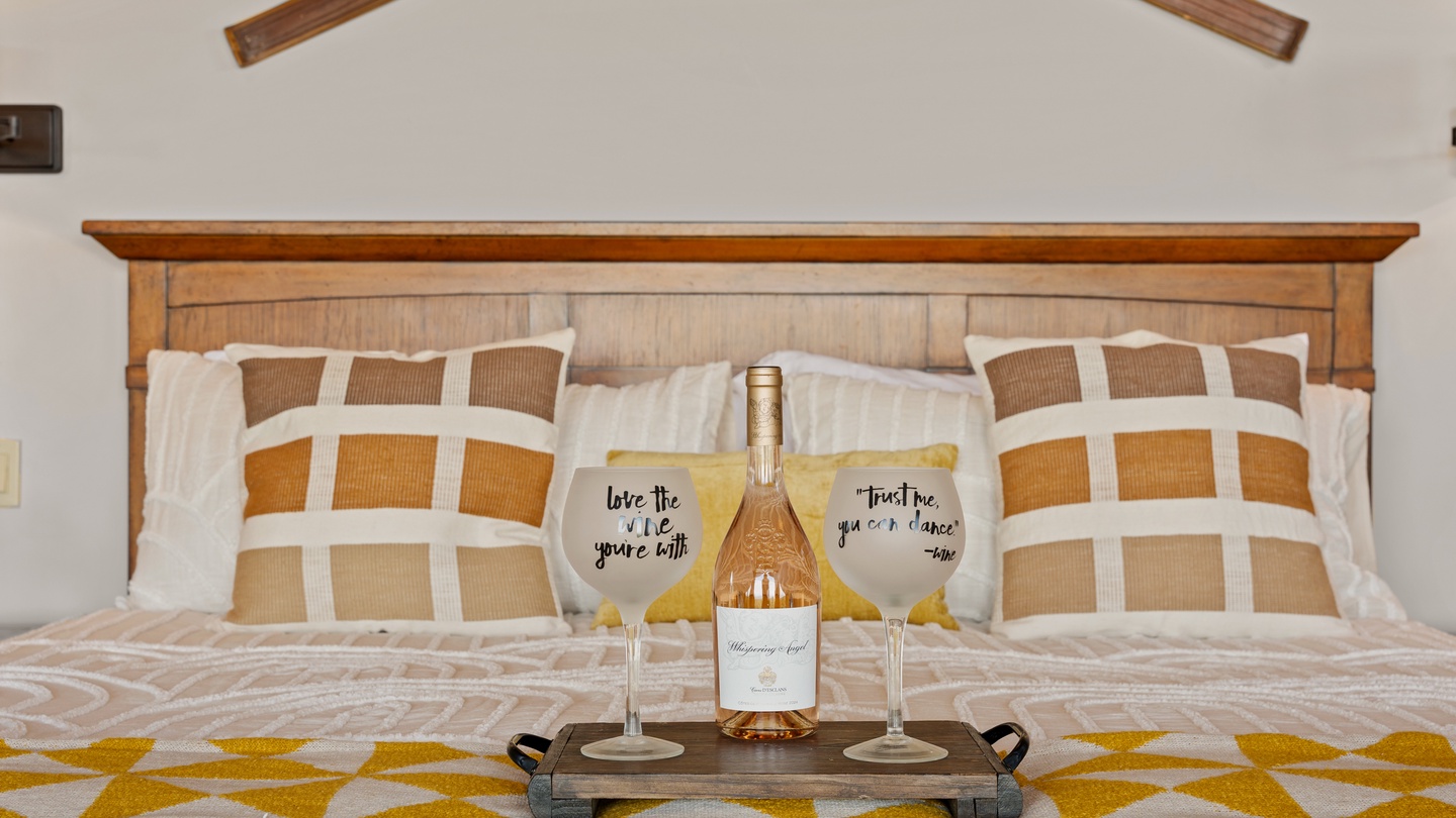 Settle into crisp linens and cozy textures under charming vaulted beams. Sip your favorite rosé and let the cheerful patterns and warm wood set the tone for your perfect getaway.