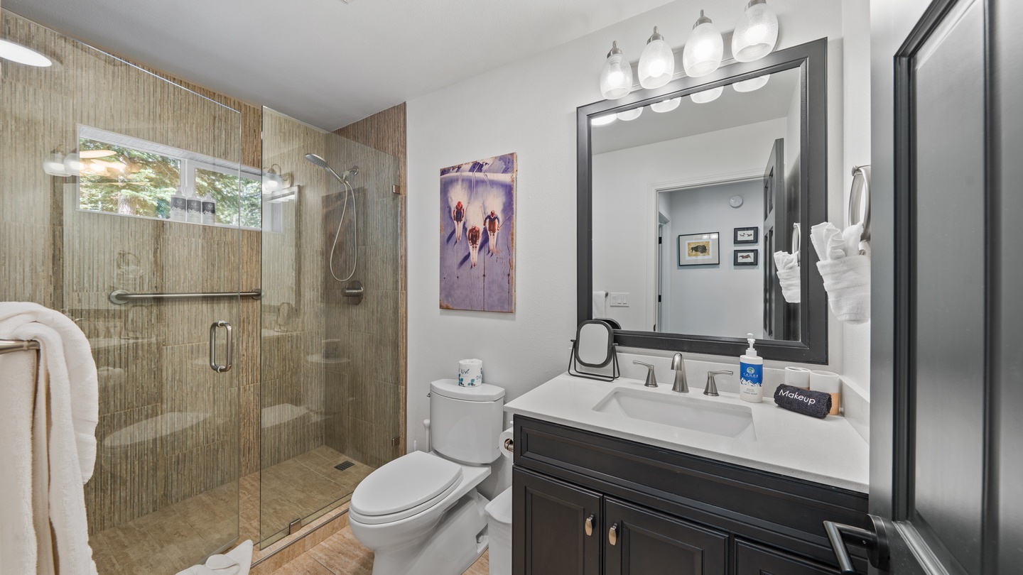 Freshen up in your modern bathroom with a spacious walk-in shower, sleek vanity, and all the comforts you need to relax after a day of exploring.