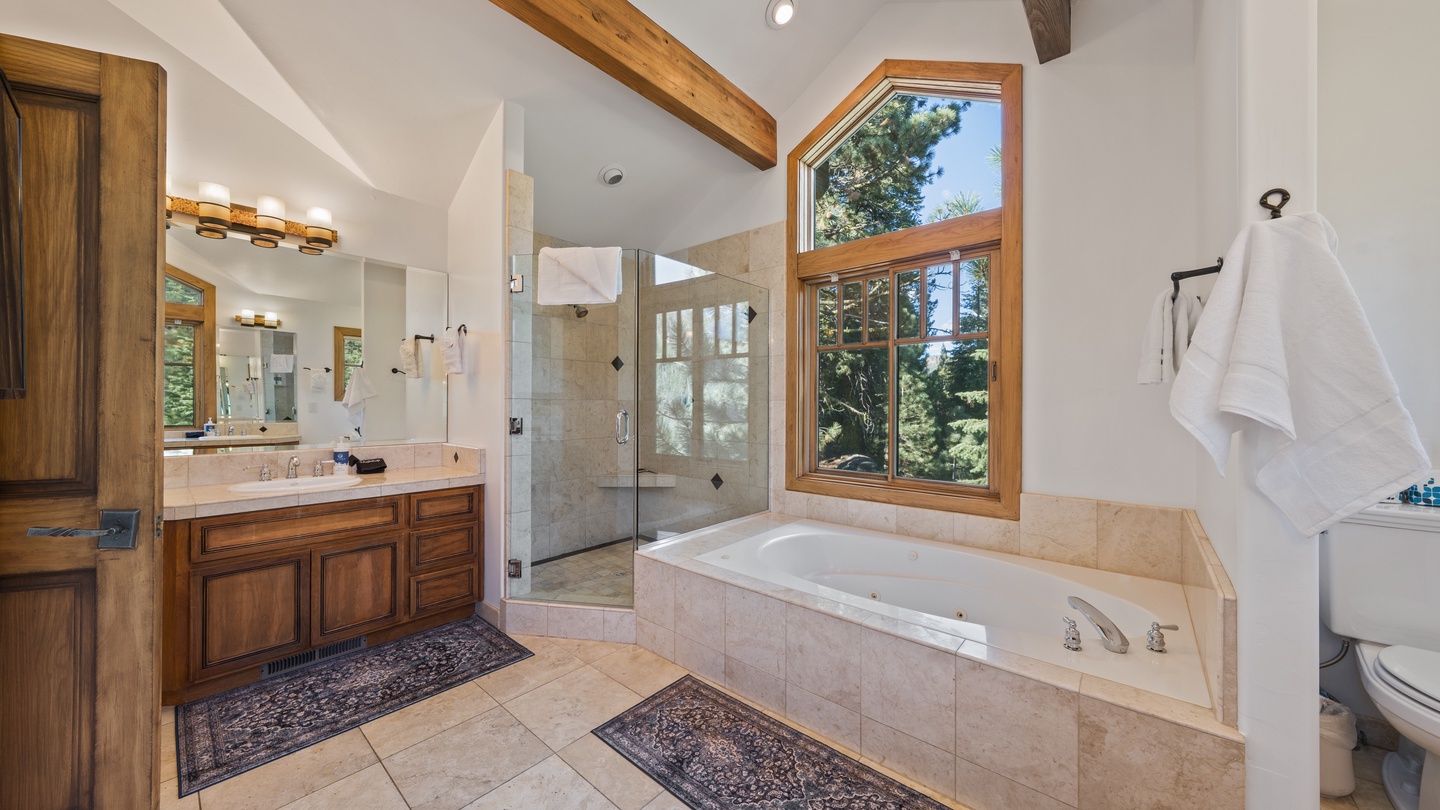 Unwind in your spa-like bathroom, where warm wood beams meet mountain views. Soak in the jetted tub, refresh in the glass-enclosed shower, and feel truly pampered.