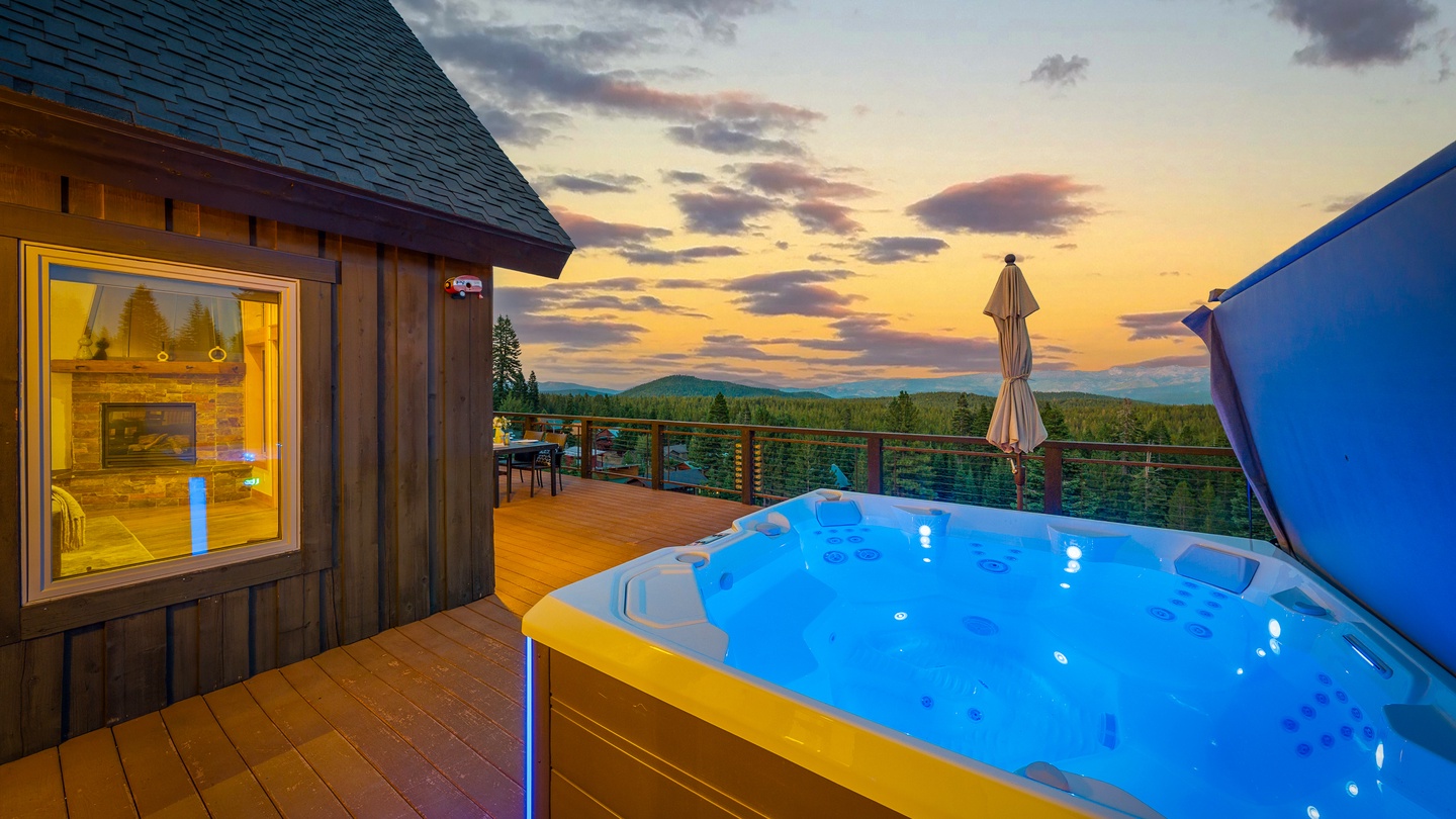 Experience stunning mountain sunsets from this private hot tub overlooking endless forest. Cozy wood interiors and a glowing fireplace create the perfect retreat for your evening soak.