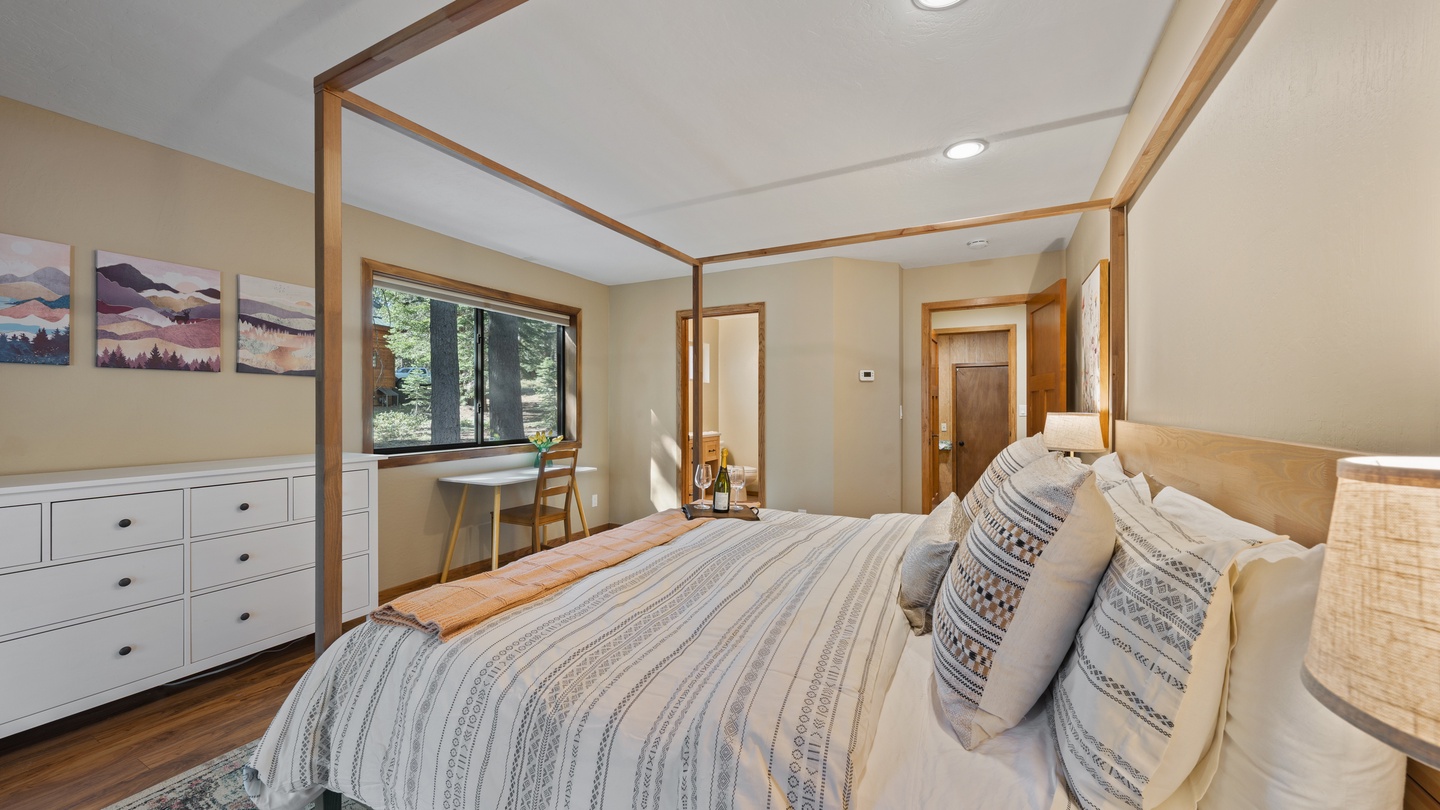 Wake up to natural light streaming through the window and towering trees just beyond. Your peaceful bedroom retreat features a plush bed, cozy seating nook, and ample storage—designed for restful mornings and quiet evenings.