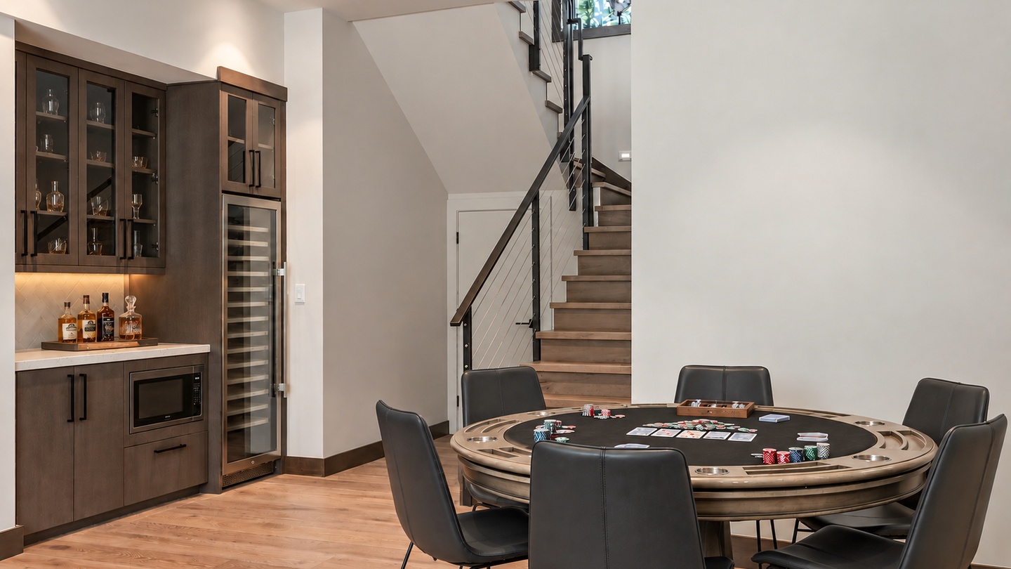 Your private game room awaits with a custom poker table, wet bar, and wine fridge—perfect for hosting lively evenings with friends.