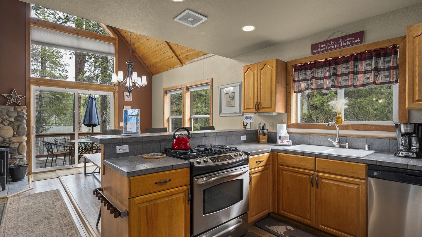 Your fully-equipped kitchen features warm wood cabinets, granite counters, and stainless appliances, perfect for creating memorable meals together.