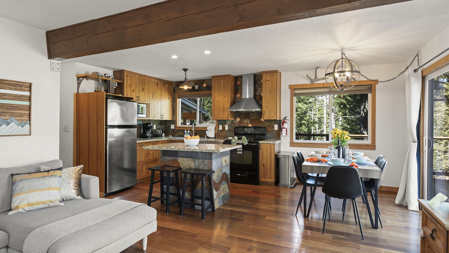 Your open-plan living space features warm wood beams, a fully equipped kitchen, and dining for six at the table and 2 more at the breakfast bar.