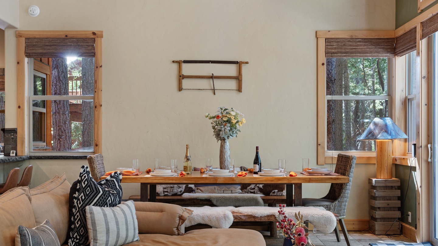 Gather around the handcrafted dining table for meals framed by forest views through every window. Natural light and rustic pine ceilings create a warm, inviting space where your best vacation memories unfold.