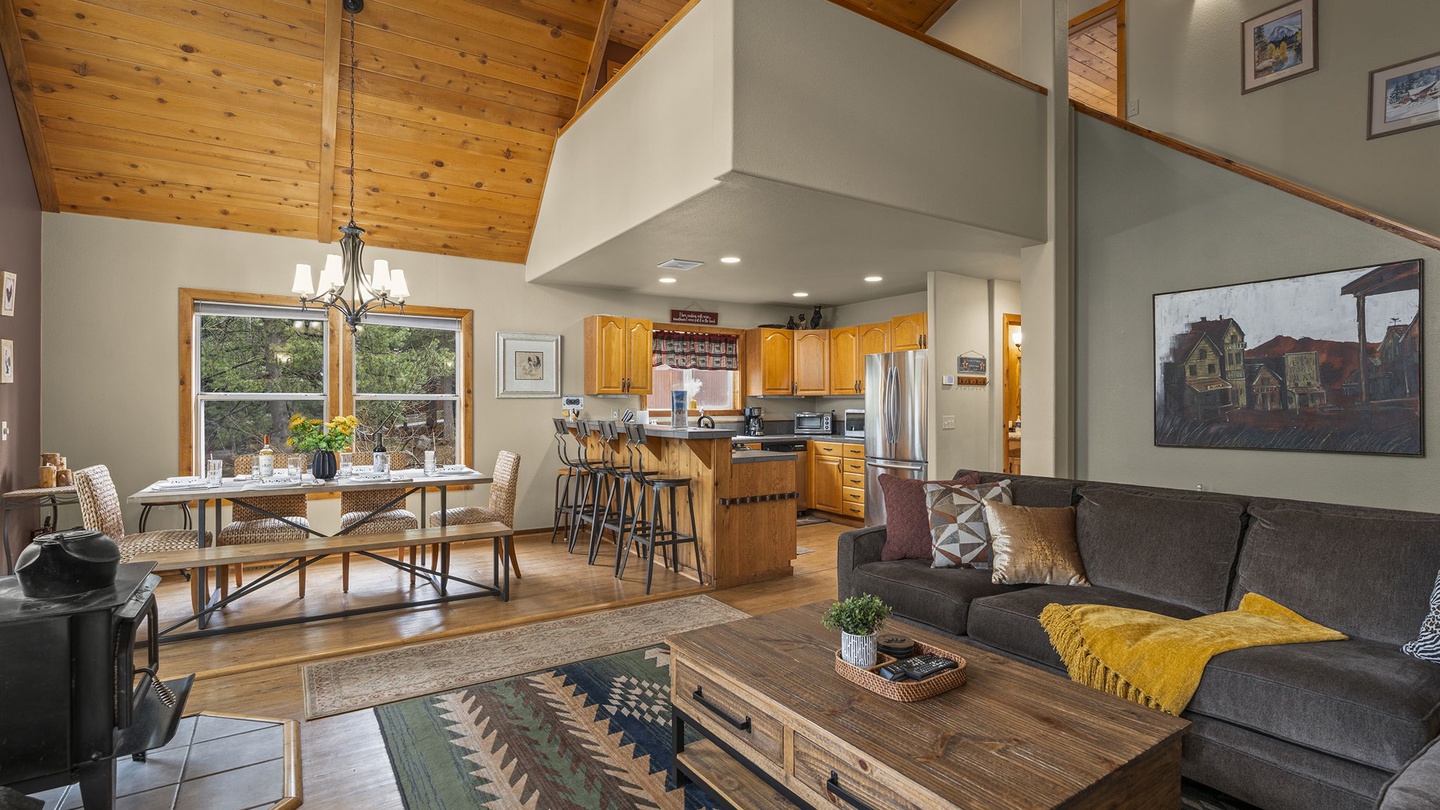 Settle into this open-concept sanctuary where soaring wood ceilings and natural light create the perfect mountain retreat atmosphere.