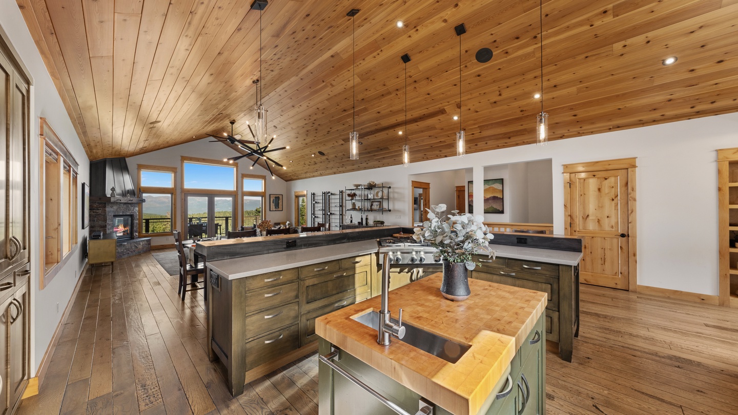 Gather around your chef-grade kitchen with its stunning wood-beam ceiling, expansive island, and natural light pouring through floor-to-ceiling windows framing mountain vistas.