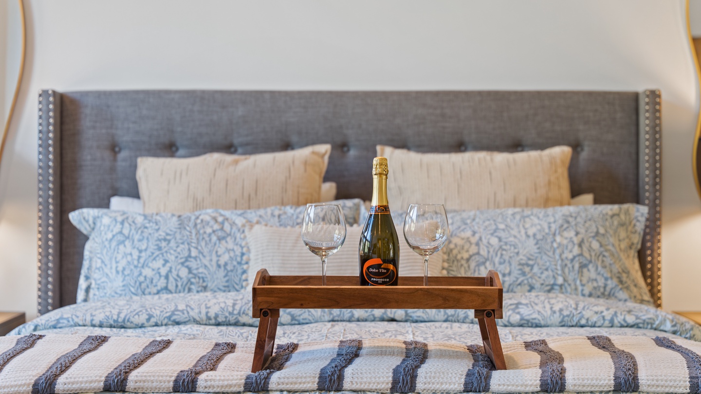 Settle in and toast to your getaway—your plush bedroom awaits with champagne and cozy linens, ready to make every moment memorable.