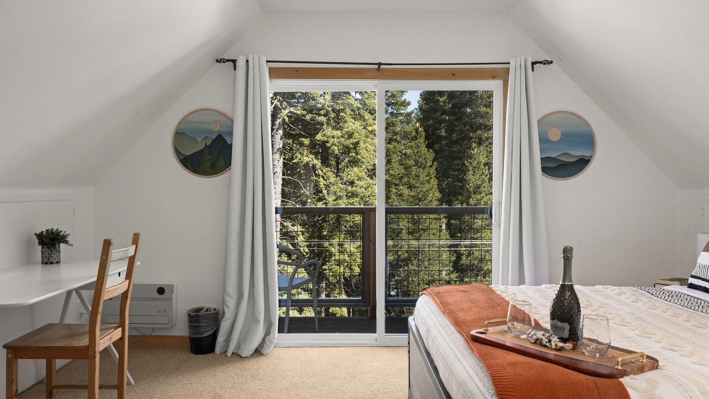 Wake up in your charming upstairs bedroom, where sloped ceilings create intimate charm and your private balcony opens to peaceful forest and lake views.