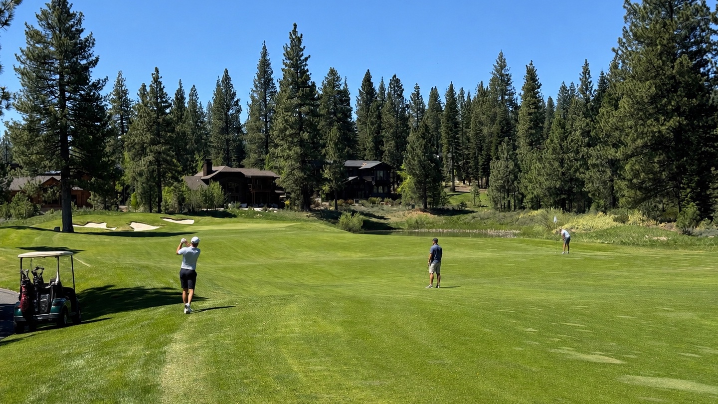 A championship golf course winds through towering pine forests with mountain homes dotting the fairways, offering an alpine retreat for golf enthusiasts.