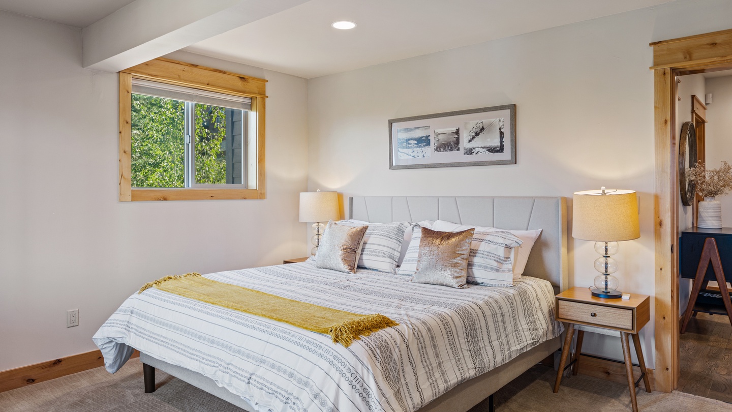Sink into soft linens and a plush headboard after a day exploring. Natural light floods this quiet retreat, while warm wood accents and gentle bedside lamps set a soothing tone for your stay.