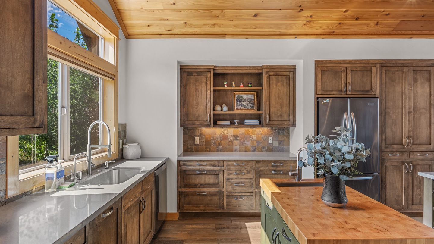 Rustic kitchen with warm wood cabinetry and butcher-block island.