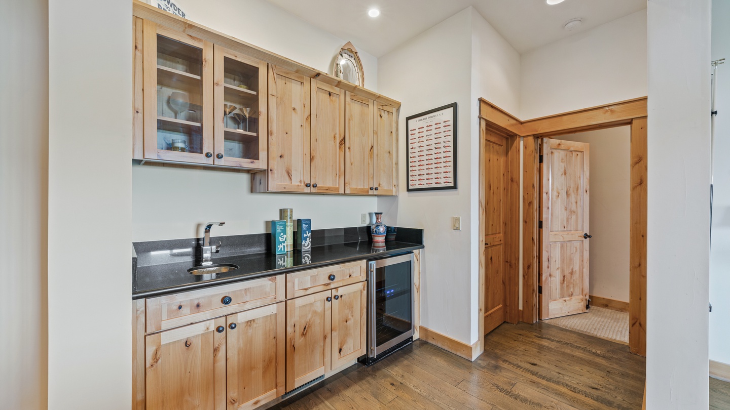 Your private kitchenette features warm wood cabinetry, granite countertops, and a compact beverage fridge—perfect for prepping snacks or chilling your favorite drinks between adventures.