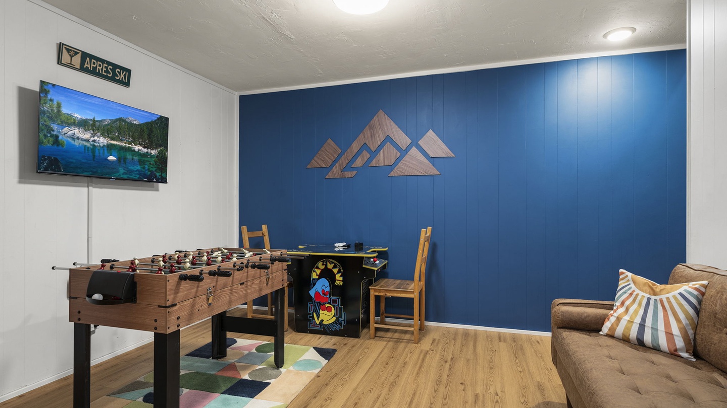 Your game room awaits with foosball, cozy seating, and mountain-themed décor for perfect après-ski relaxation.