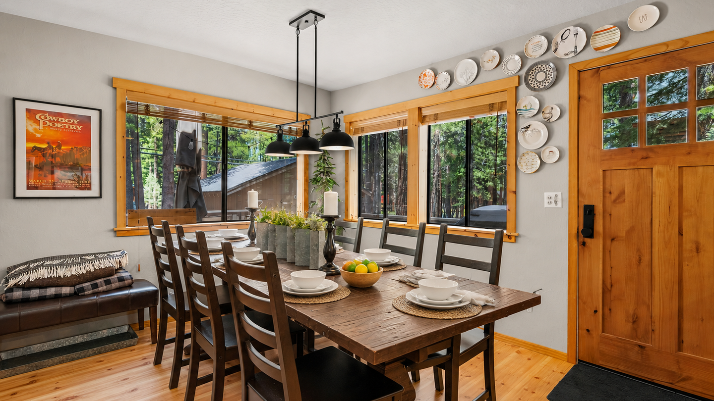 Gather around the rustic wood table with your loved ones, where natural light floods through oversized windows and the forest feels just beyond reach.