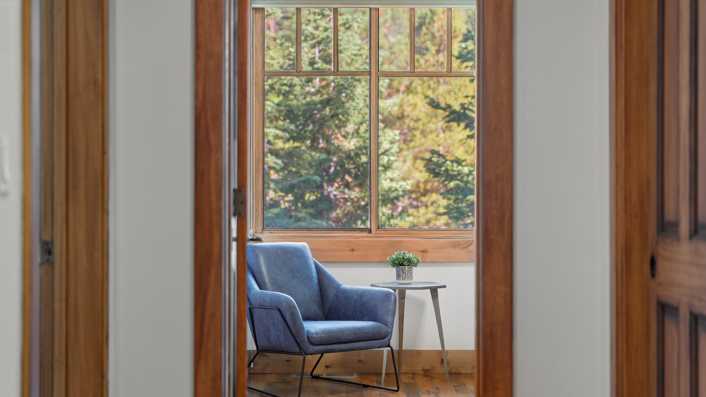 Curl up in this inviting reading nook with a book and watch sunlight filter through the trees—your own peaceful corner for quiet moments.
