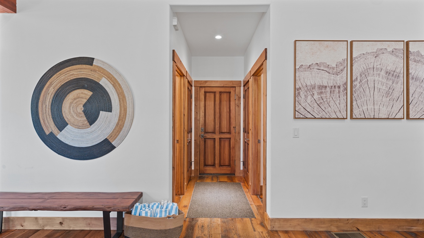 A warm entryway welcomes you with rich wooden floors and thoughtful artwork. Your home away from home awaits beyond that beautifully crafted door.