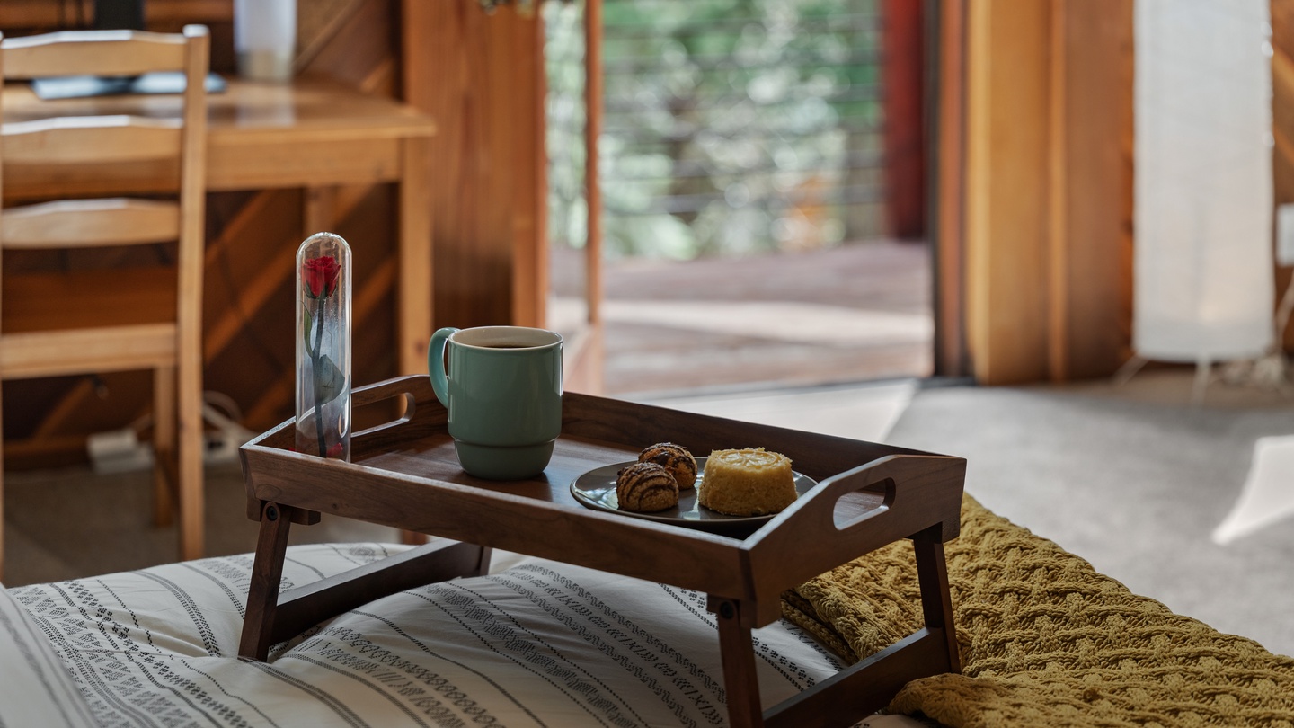 Start your morning with breakfast in bed, complete with fresh pastries and coffee on a charming wooden tray—your perfect getaway begins right here.