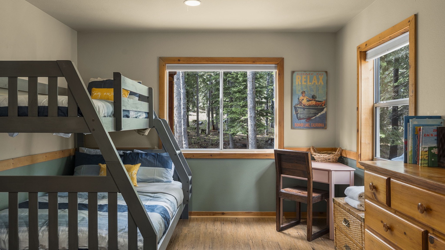 Your kids will love this cozy bunk room with forest views, perfect for bedtime stories and morning adventures.