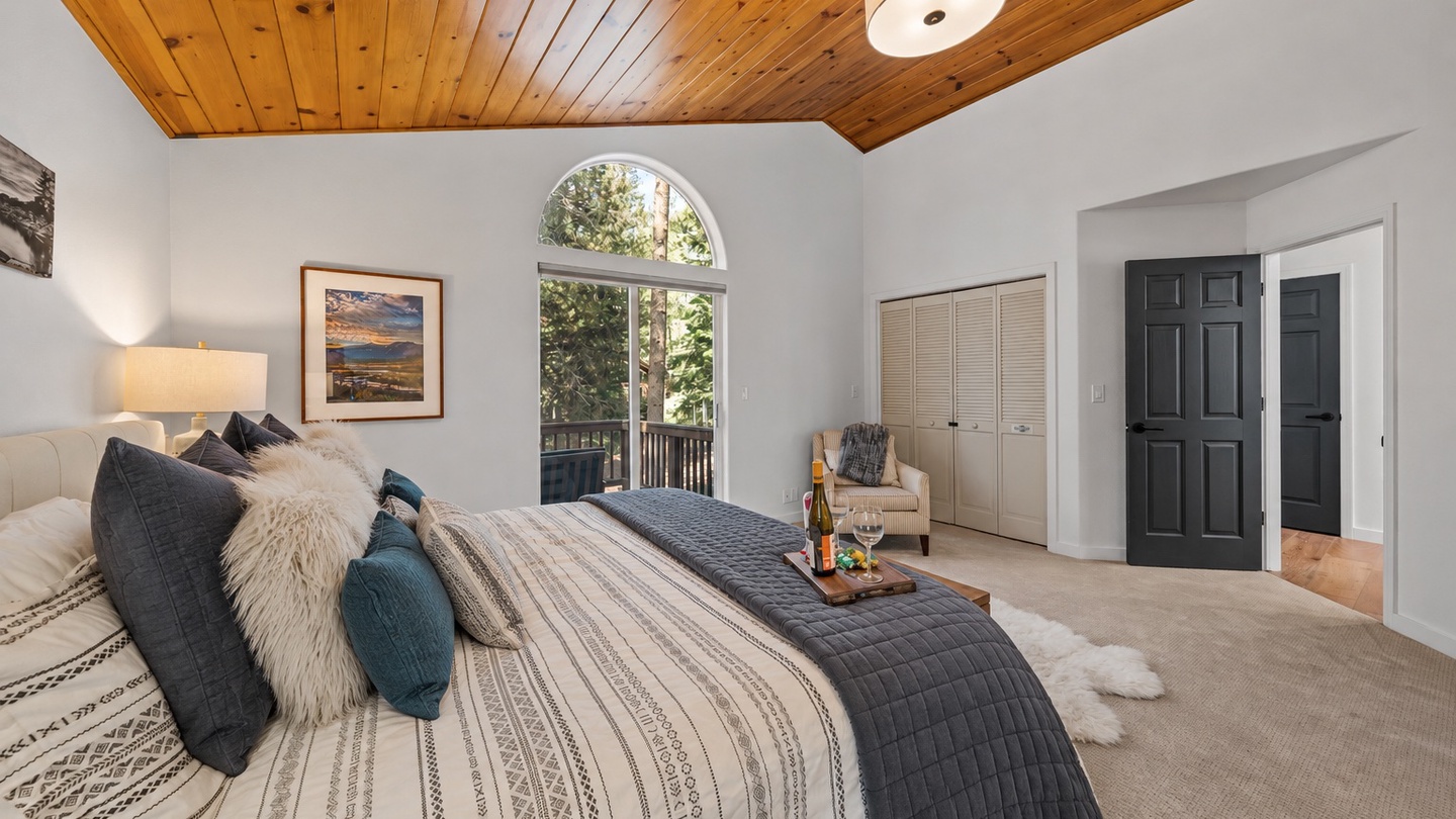 Sink into plush bedding beneath warm wood ceilings and wake to natural light streaming through arched windows. Your serene retreat awaits.