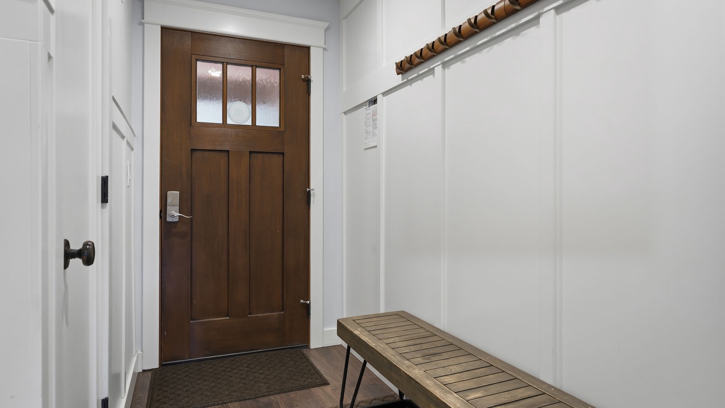 Your welcoming entryway features convenient coat storage and a cozy bench for settling in after your adventures.