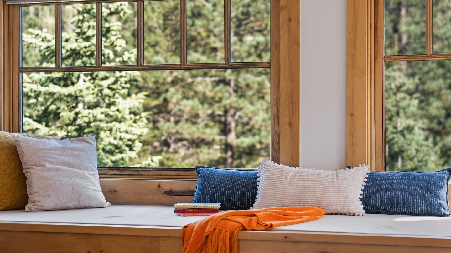 Sink into your cozy window seat with a good book and watch the forest come alive just beyond the glass—your peaceful retreat among the trees awaits.