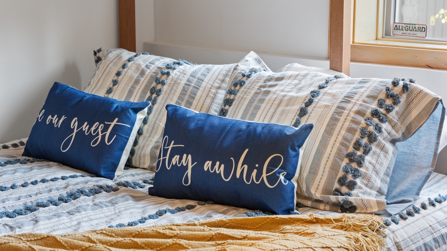 Sink into cozy layers and let the day's worries melt away—your inviting bed awaits with soft linens and welcoming touches that make you feel instantly at home.