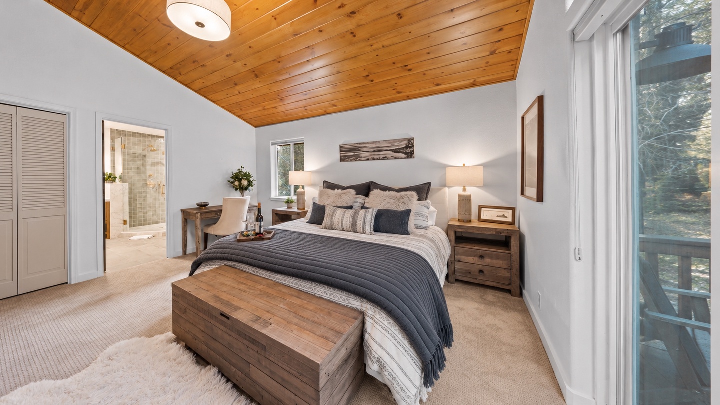 Relax in your spacious bedroom with warm wood-paneled ceilings and large windows overlooking the trees. Your private ensuite and cozy bed create the perfect retreat after a day of exploring.