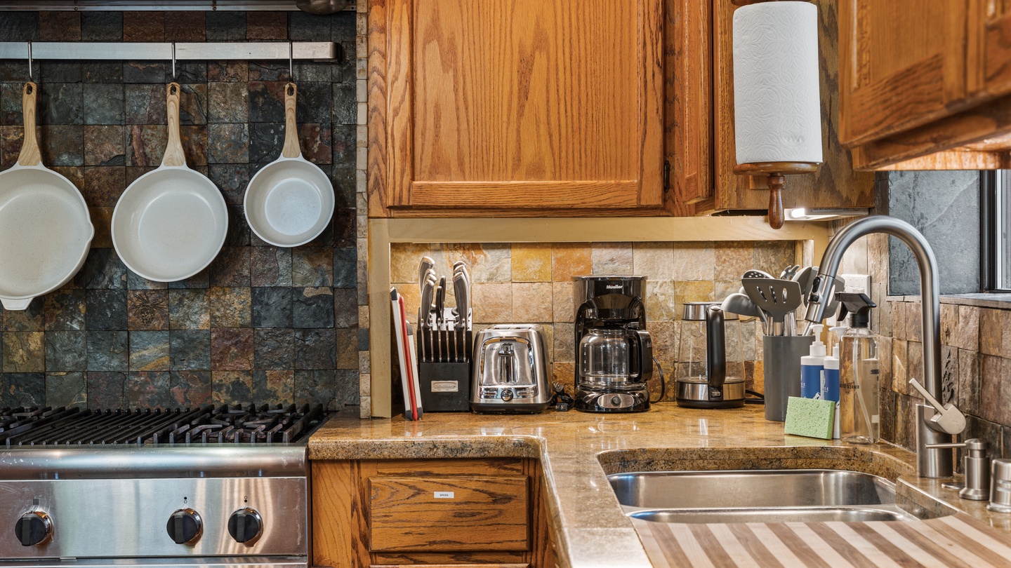 Your fully equipped kitchen features everything you need, from a professional stove to coffee makers, blenders, and stylish rustic details—making it easy to whip up meals or enjoy your morning brew.