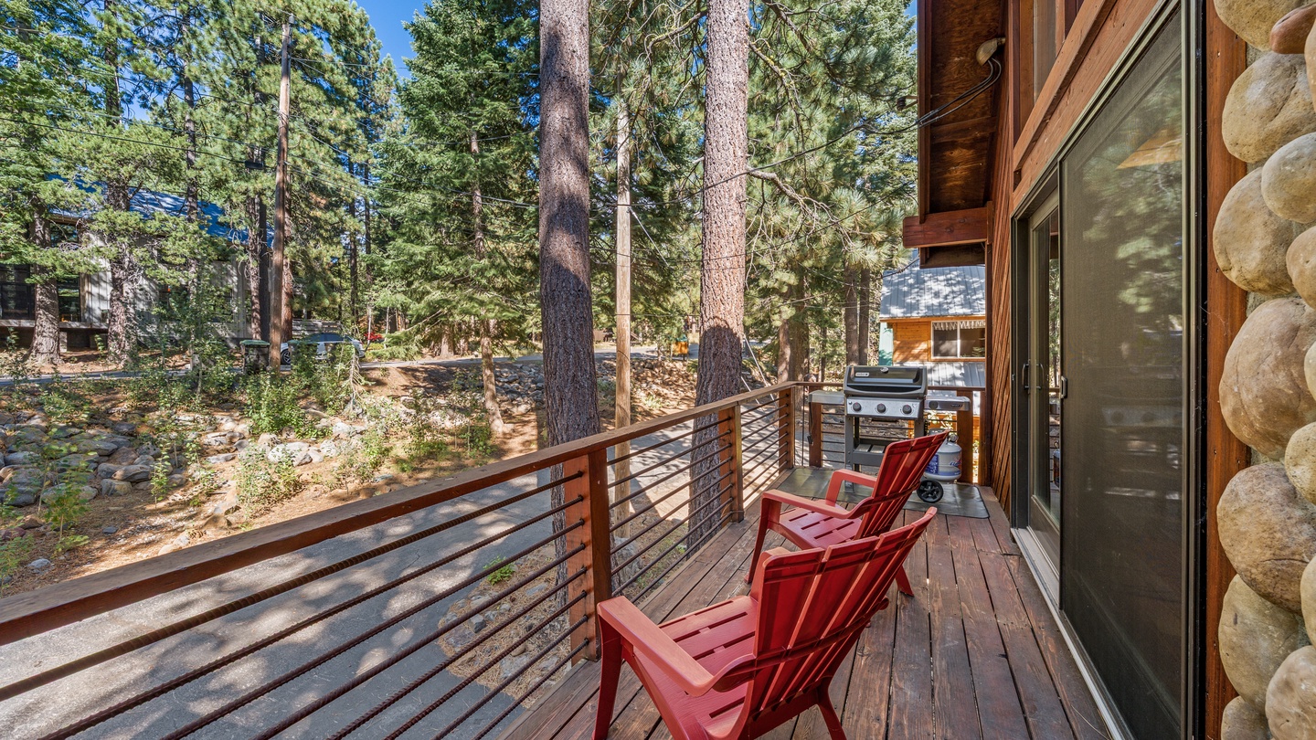 Step onto your private deck nestled among towering pines, where red Adirondack chairs invite you to unwind with morning coffee or fire up the grill for a mountain feast.