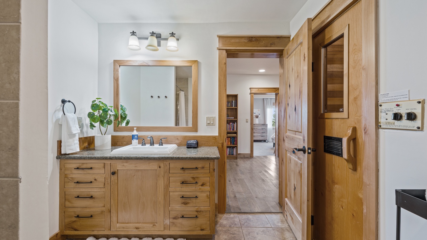 Freshen up in your beautifully appointed bathroom featuring custom woodwork, granite countertops, and bright natural light streaming in through the space.