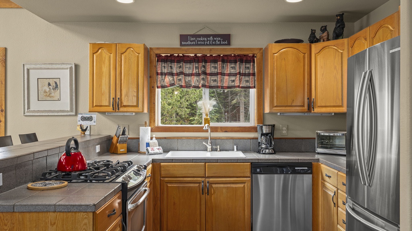 Your fully equipped kitchen awaits with gleaming stainless appliances, granite counters, and everything you need for home-cooked meals.