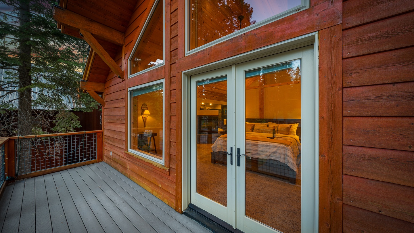This charming cedar cabin nestled among towering pines features a private balcony with forest views—your peaceful mountain retreat awaits at sunset.