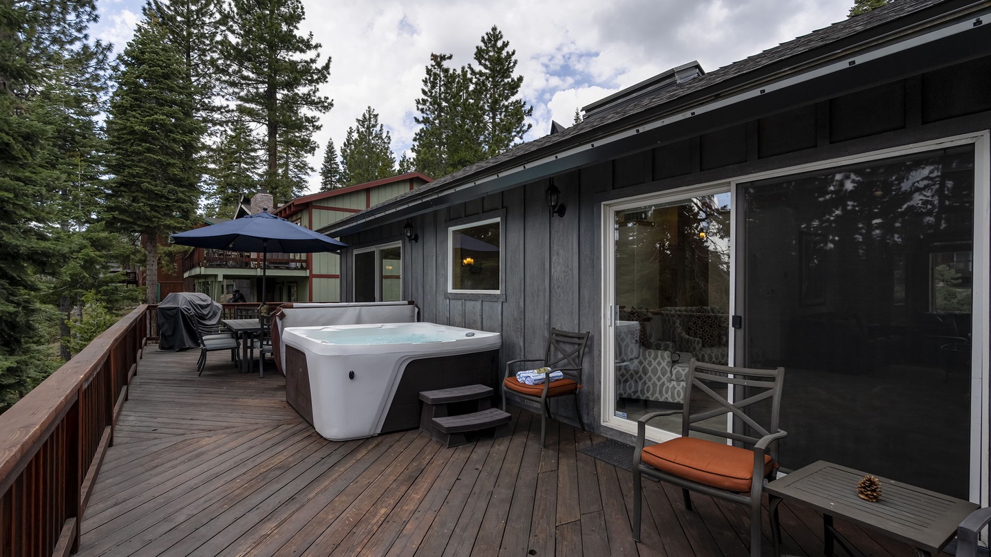 Main Floor: large patio with a hot tub with seating area
