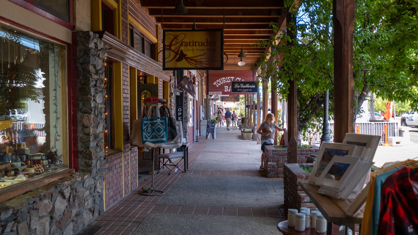 Charming downtown sidewalk with local shops, cafes, and unique boutiques creating a perfect walkable neighborhood setting.