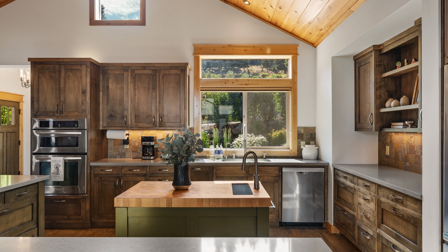 Step into this warm, light-filled kitchen with vaulted wood ceilings, rich cabinetry, and a welcoming island perfect for sharing meals and making memories together.