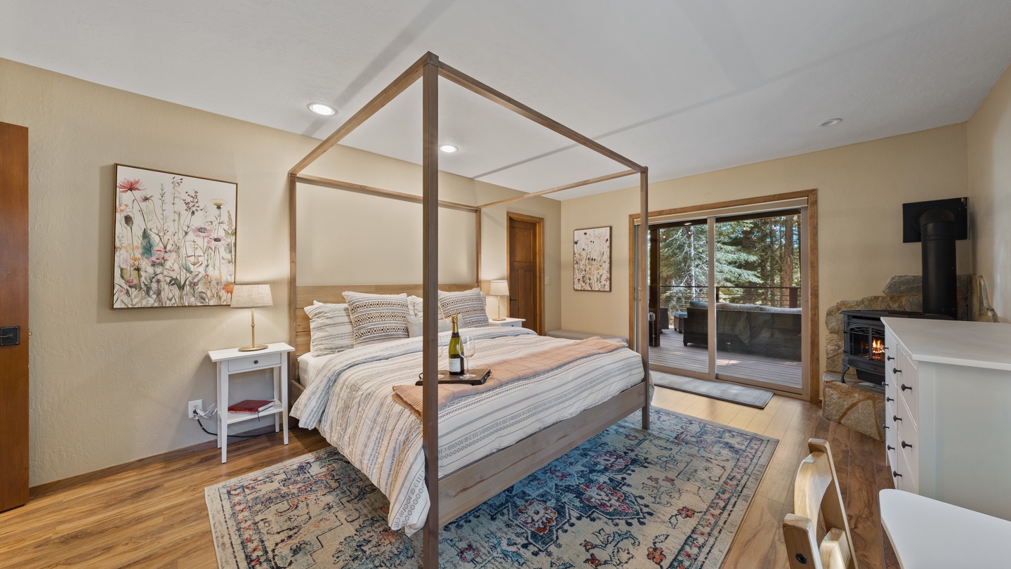 Sink into your elegant canopy bed and gaze at the towering trees beyond your private balcony—perfect for sipping morning coffee or unwinding with a glass of wine by the fireplace.
