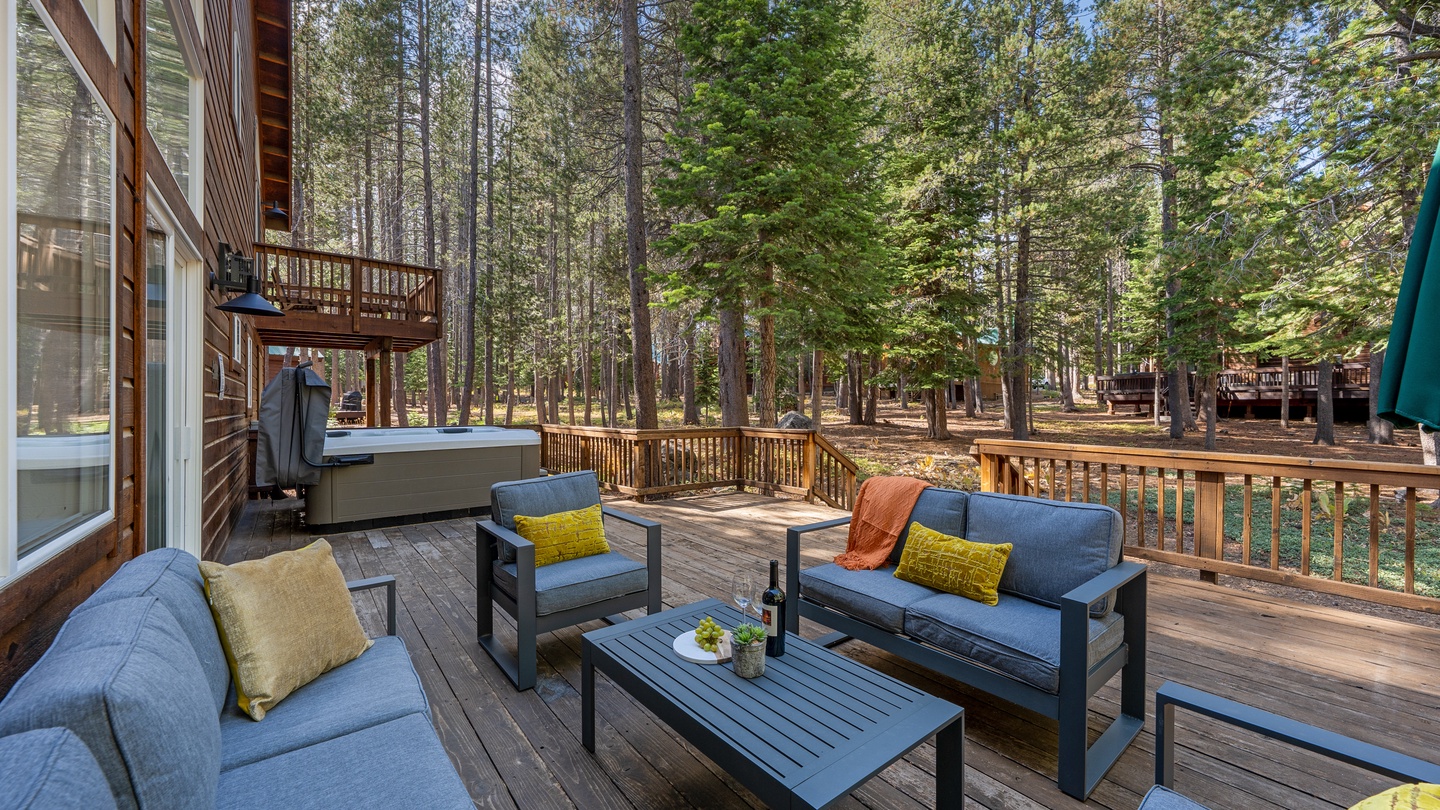 Unwind on your private deck surrounded by towering pines. Sink into comfortable seating with a glass of wine as sunlight filters through the forest canopy, creating your perfect mountain escape.