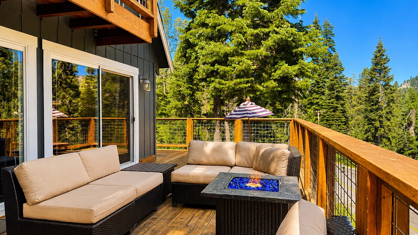 Sink into plush lounge seating on your private deck, surrounded by towering evergreens and bathed in mountain sunshine—your perfect spot to unwind with morning coffee or evening conversation.