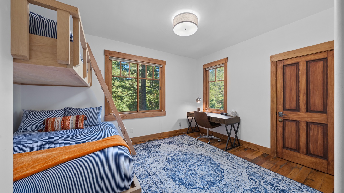 Step into this bright bedroom featuring custom-built bunk beds, perfect for kids or guests. The warm wood tones and natural light create a cozy, restful retreat you'll love coming home to.