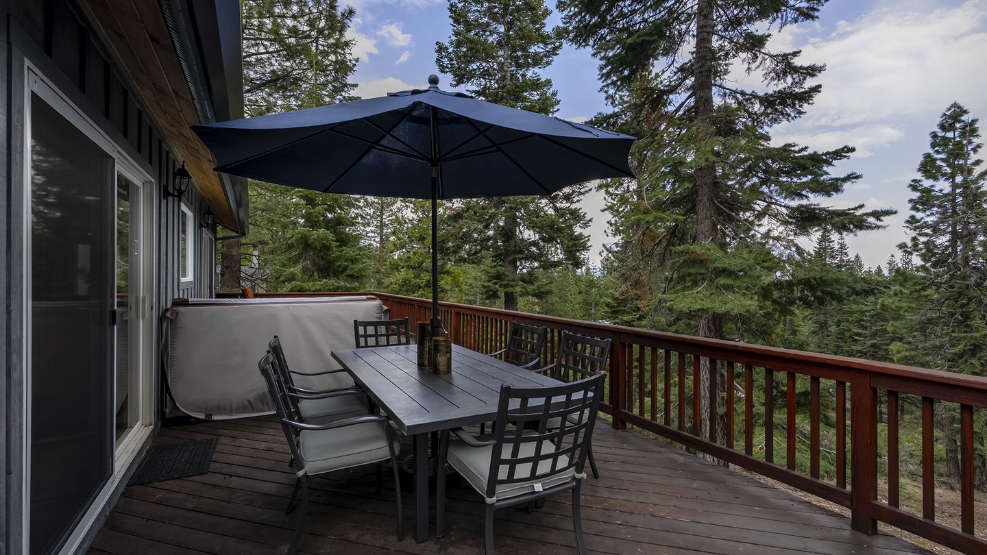 Main Floor: large patio with a hot tub with seating area