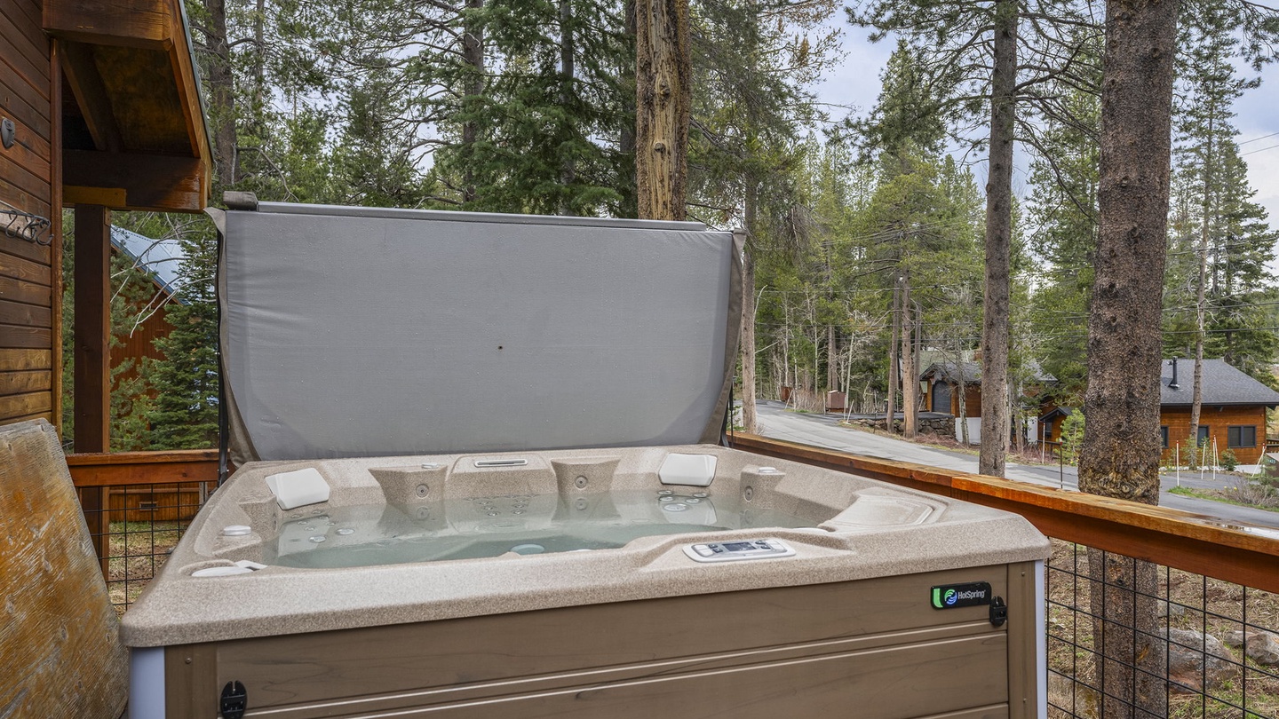 Soak in your private hot tub while enjoying tranquil forest views and mountain air from your deck.