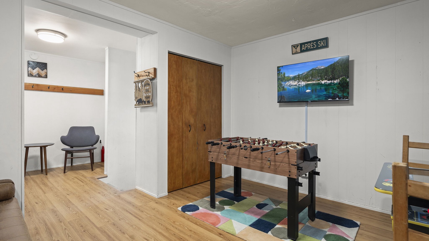 Challenge friends to foosball in your game room, complete with TV entertainment and cozy seating nook.