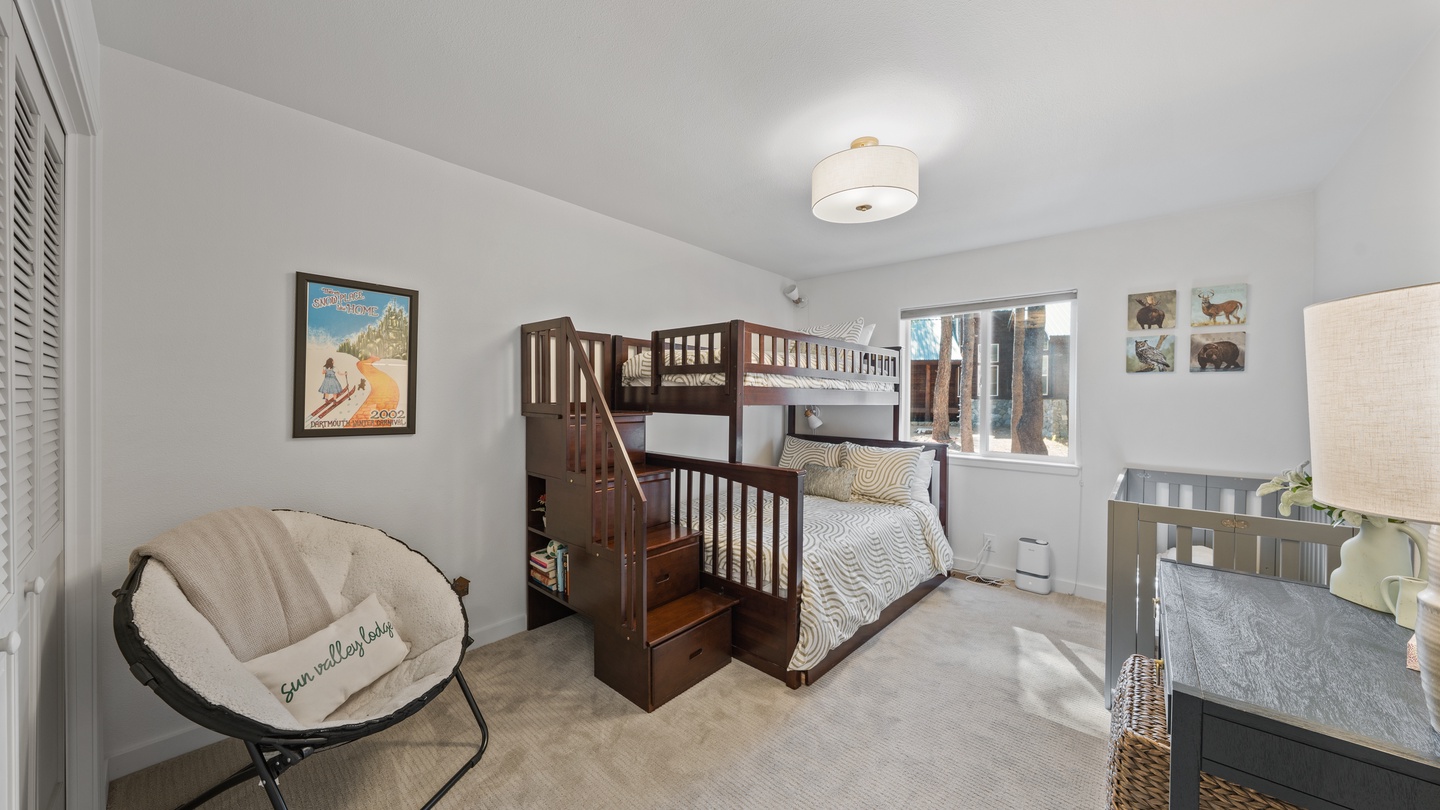 Cozy room with bunk beds and built-in storage, perfect for kids to enjoy their own space during your family getaway.