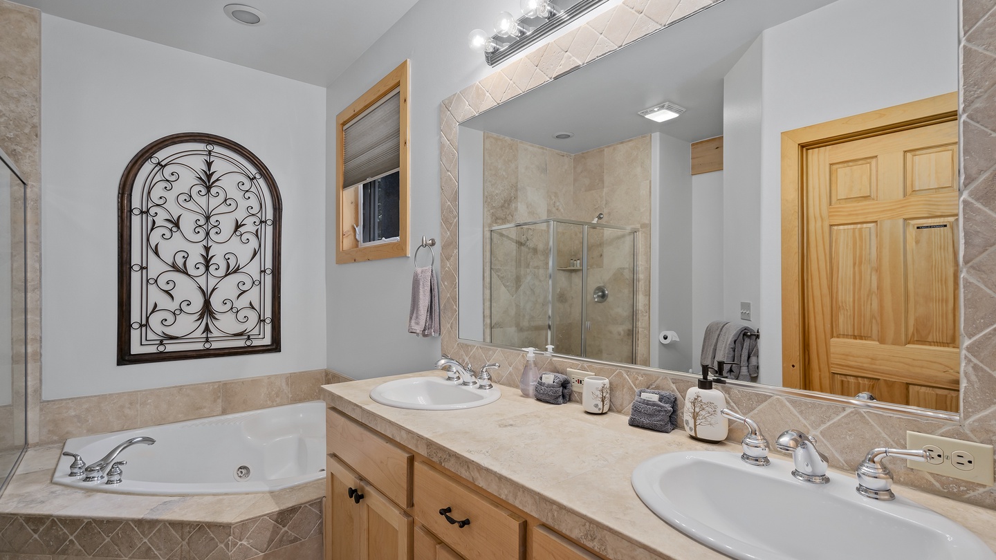 Unwind in your private bathroom with dual sinks, a soaking tub, and a spacious walk-in shower—perfect for refreshing after a day of adventure.